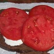 Sliced Abe Lincoln on pumperknickel bread: The Perfect Tomato San